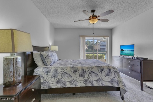 bedroom featuring ceiling fan, a textured ceiling, and carpet