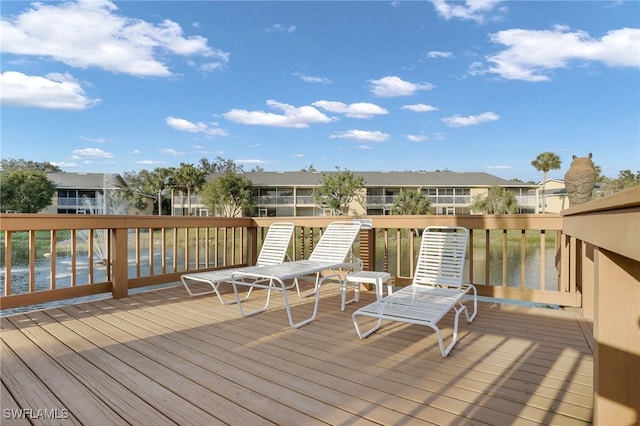 wooden deck featuring a water view