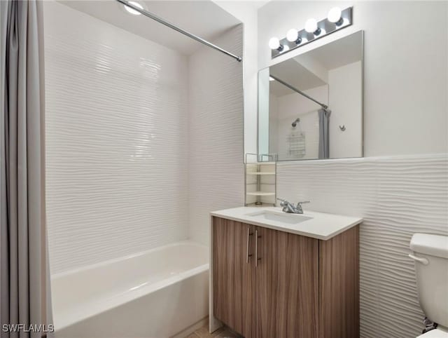 full bathroom featuring tile walls, toilet, shower / tub combination, and vanity