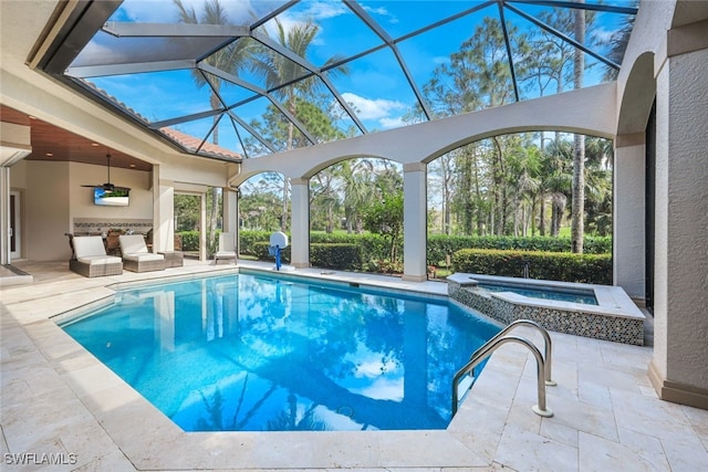 view of pool with an in ground hot tub, ceiling fan, glass enclosure, and a patio area