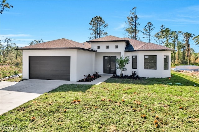 view of front of property with a garage and a front lawn