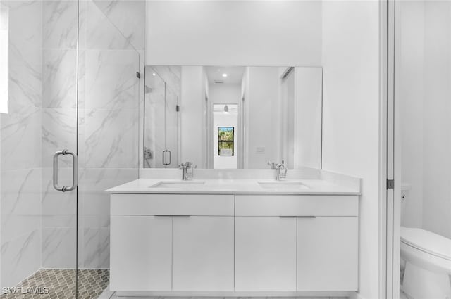 bathroom with vanity, toilet, and an enclosed shower