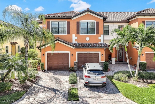 mediterranean / spanish-style house with a garage