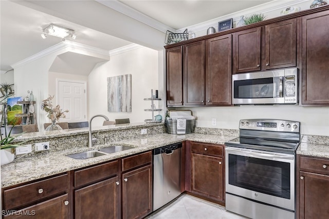 kitchen with light stone countertops, sink, stainless steel appliances, and ornamental molding