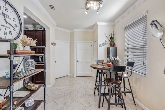 tiled dining room with crown molding