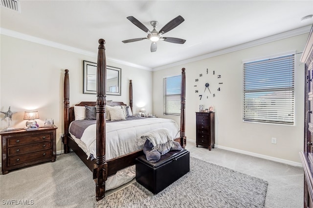 carpeted bedroom featuring ceiling fan and crown molding