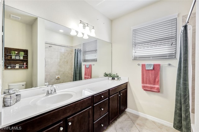 bathroom featuring toilet, tile patterned flooring, and vanity