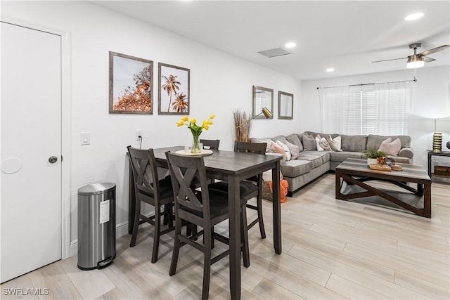 dining area with ceiling fan and light hardwood / wood-style floors