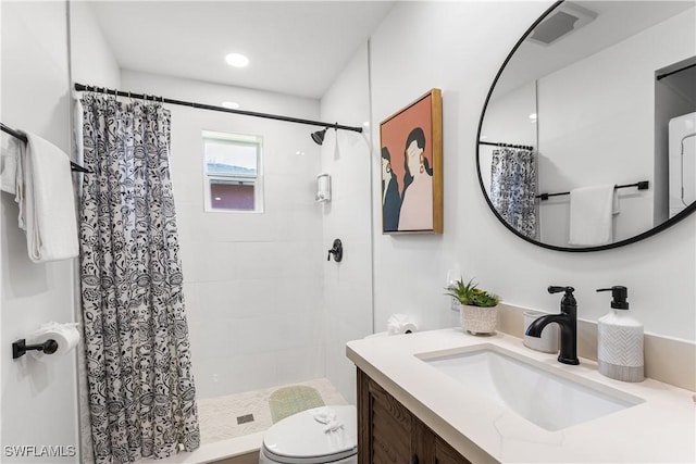 bathroom with toilet, vanity, and curtained shower