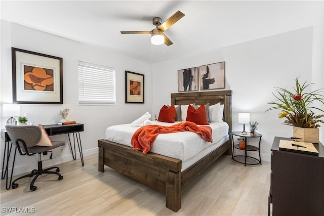 bedroom with ceiling fan and light hardwood / wood-style flooring