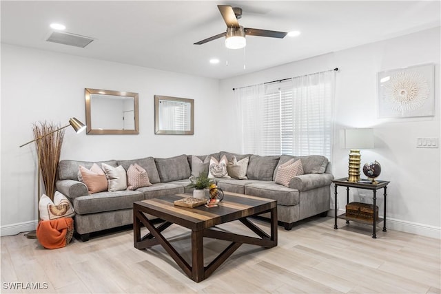 living room with ceiling fan and light hardwood / wood-style flooring