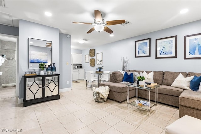 living room featuring ceiling fan and light tile patterned floors