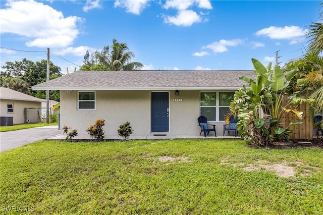 view of front of home featuring a front yard and cooling unit