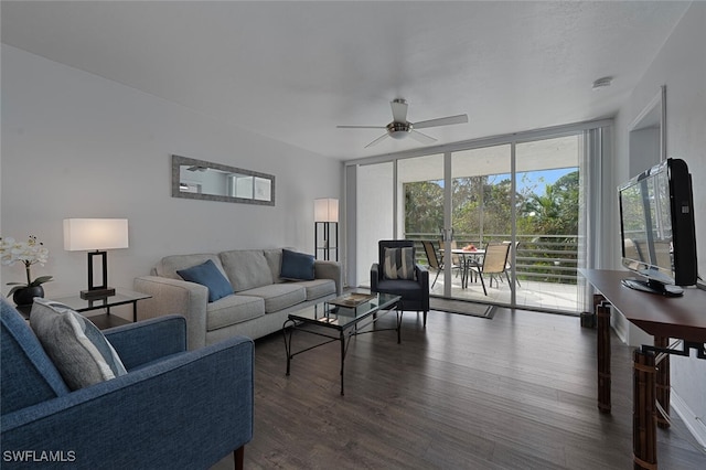 living room featuring ceiling fan, dark wood-type flooring, and a wall of windows