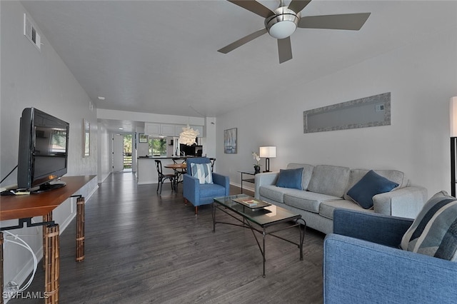 living room with ceiling fan and dark hardwood / wood-style flooring