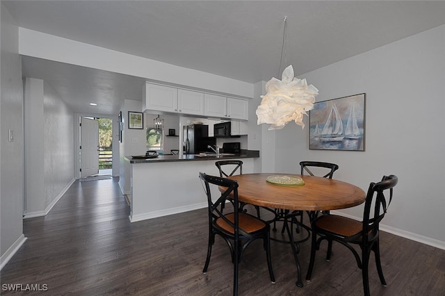 dining room with dark wood-type flooring and sink