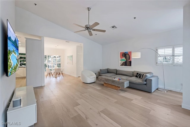 living room with light hardwood / wood-style flooring, plenty of natural light, lofted ceiling, and ceiling fan