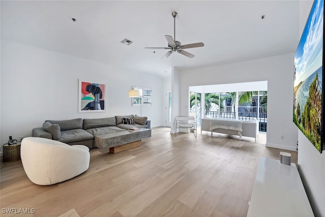 living room featuring light hardwood / wood-style flooring and ceiling fan