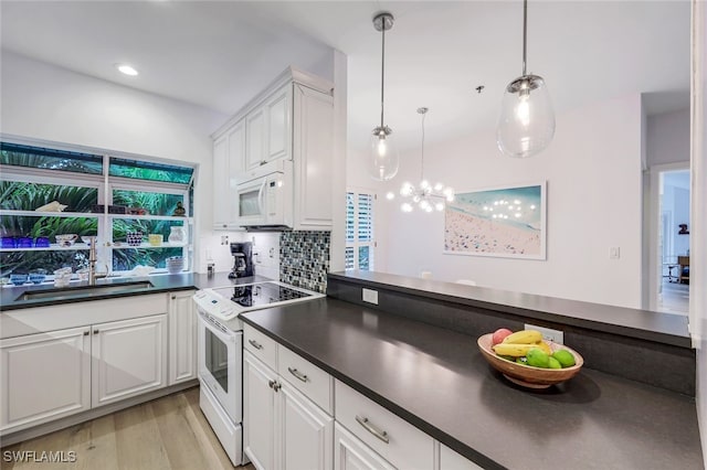 kitchen featuring sink, white cabinetry, pendant lighting, white appliances, and decorative backsplash