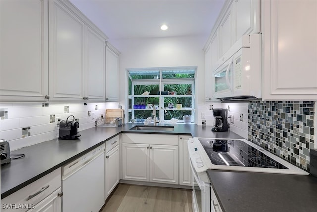 kitchen with white cabinetry, sink, white appliances, and decorative backsplash