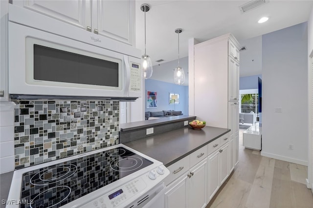 kitchen with white cabinetry, light hardwood / wood-style flooring, pendant lighting, white appliances, and backsplash