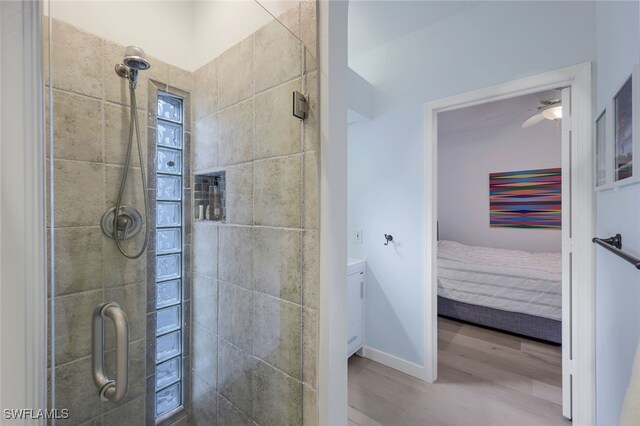 bathroom featuring an enclosed shower and hardwood / wood-style flooring