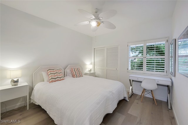 bedroom featuring hardwood / wood-style floors, ceiling fan, and a closet