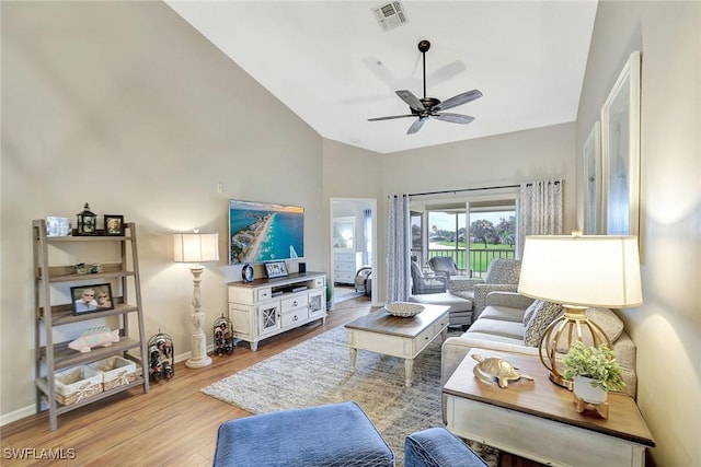 living room with light hardwood / wood-style floors, lofted ceiling, and ceiling fan