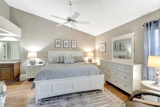 bedroom with light hardwood / wood-style floors, vaulted ceiling, and ceiling fan