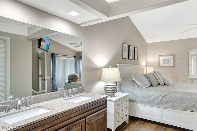 bedroom featuring sink, wood-type flooring, lofted ceiling, and ceiling fan