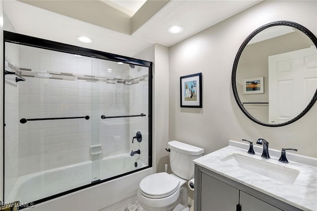 full bathroom featuring shower / bath combination with glass door, vanity, and toilet