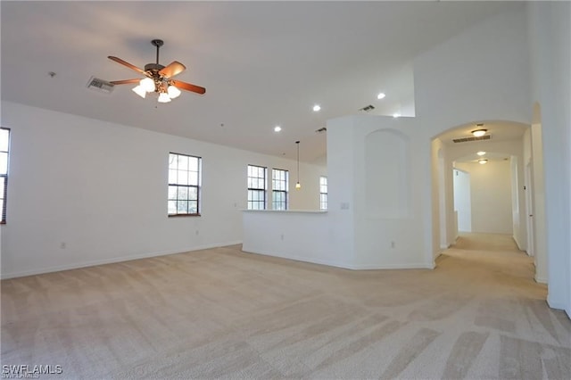 unfurnished room featuring ceiling fan, light colored carpet, and lofted ceiling