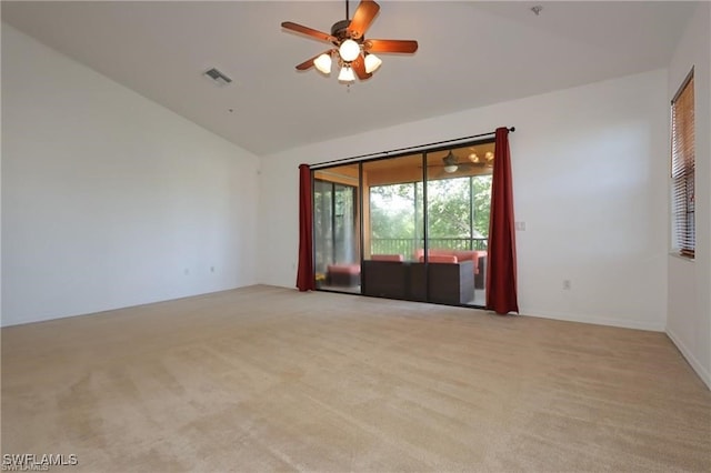 carpeted empty room featuring ceiling fan and lofted ceiling