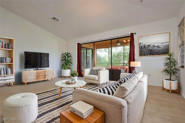 carpeted living room featuring vaulted ceiling