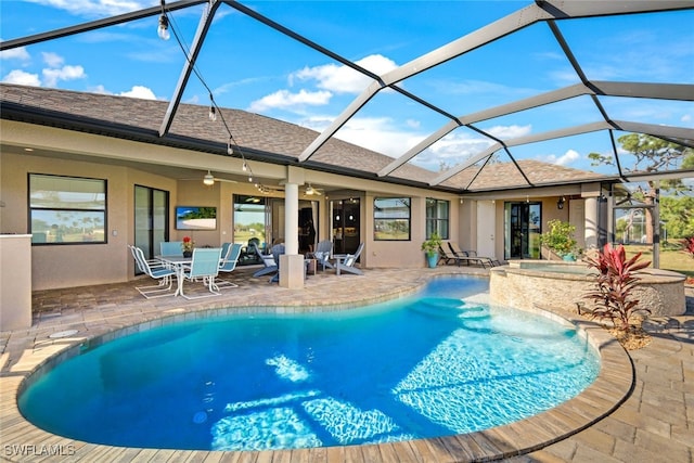 view of pool featuring ceiling fan, glass enclosure, an in ground hot tub, and a patio