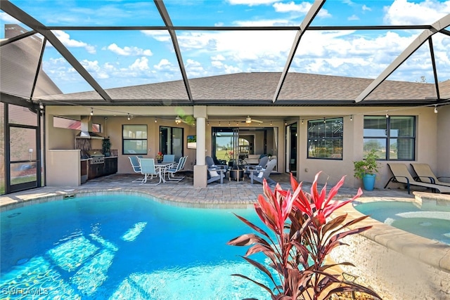 view of pool featuring ceiling fan, a patio area, an outdoor kitchen, and a hot tub