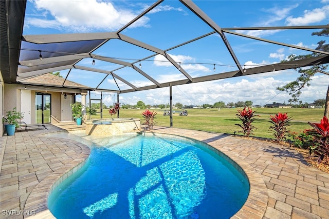 view of pool with glass enclosure, an in ground hot tub, a yard, and a patio