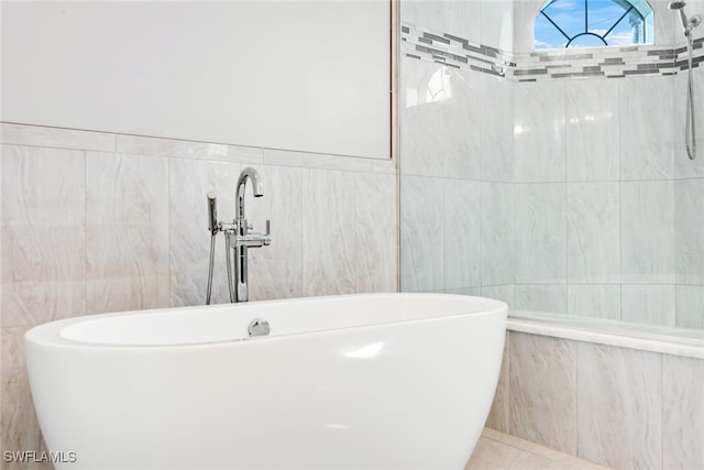 bathroom with tile walls, sink, and shower with separate bathtub