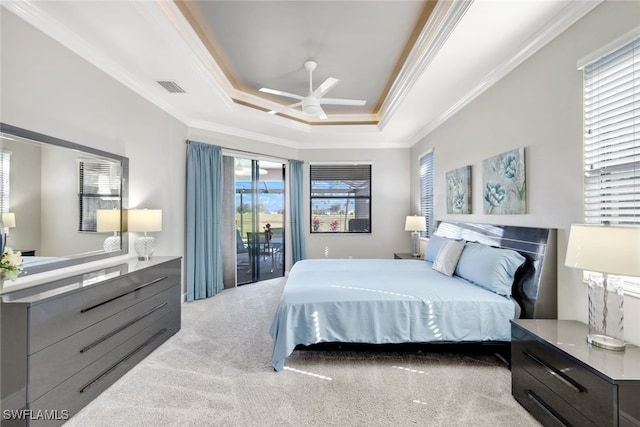 bedroom with access to exterior, a raised ceiling, ceiling fan, light colored carpet, and crown molding