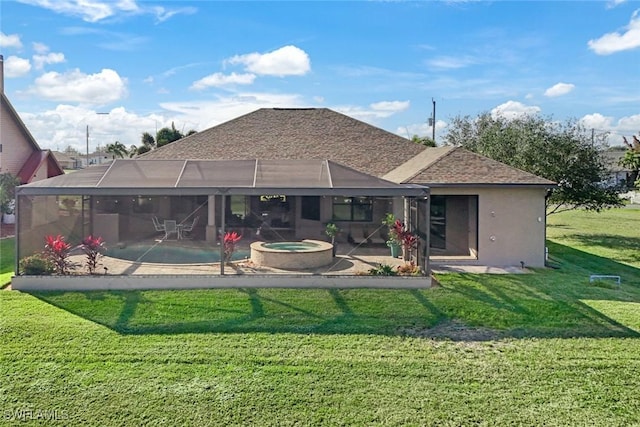 rear view of property with a lanai, a pool with hot tub, a yard, and a patio