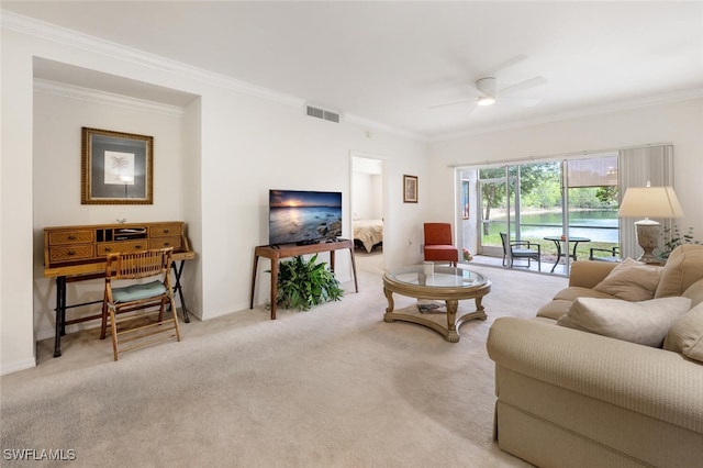 living room with ceiling fan, light colored carpet, and ornamental molding