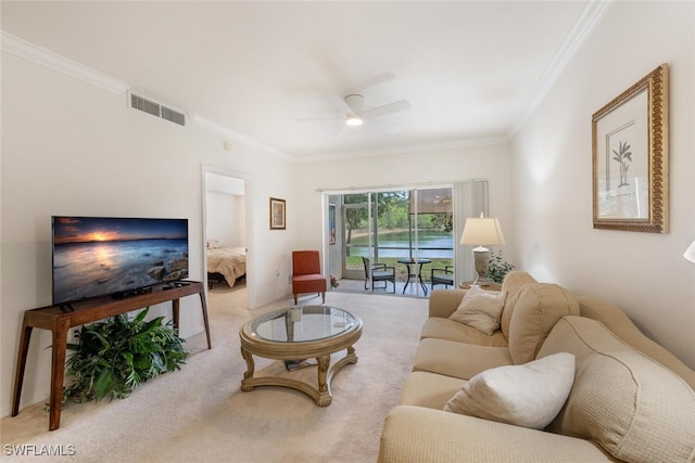 living room featuring ceiling fan, light colored carpet, and ornamental molding