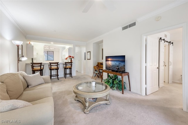 living room featuring ornamental molding, light carpet, and a barn door