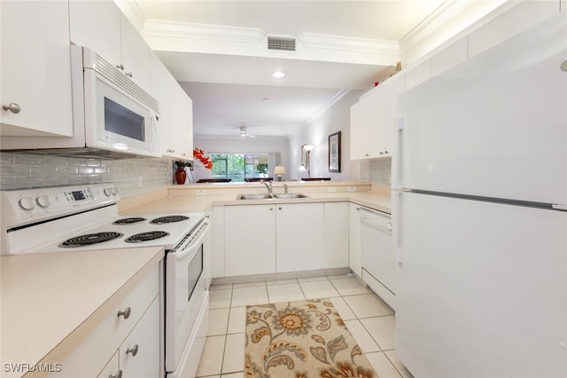 kitchen with light tile patterned floors, sink, white appliances, and white cabinetry