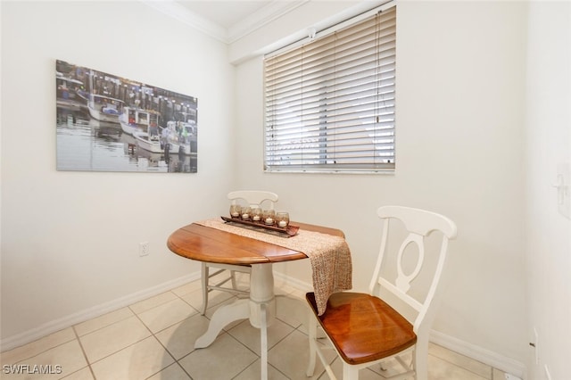 tiled dining area featuring crown molding