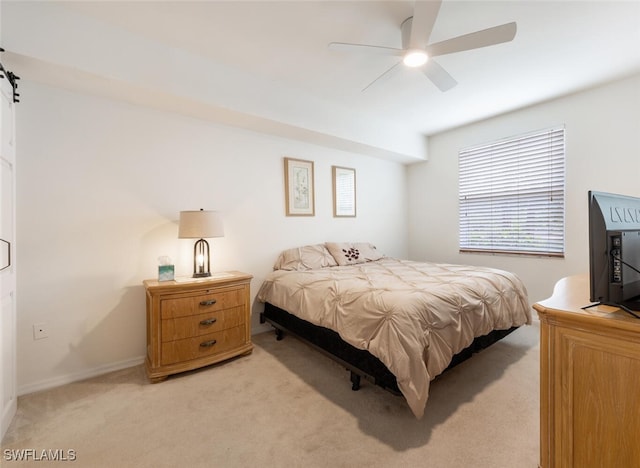 bedroom featuring ceiling fan and light carpet