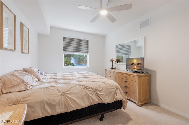 bedroom featuring ceiling fan and light carpet