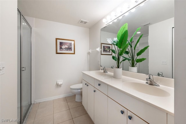 bathroom featuring toilet, tile patterned flooring, a shower with shower door, and vanity