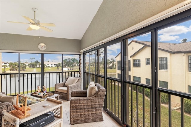 sunroom / solarium featuring ceiling fan, a water view, and a healthy amount of sunlight