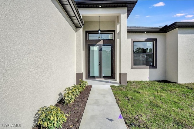 doorway to property featuring stucco siding